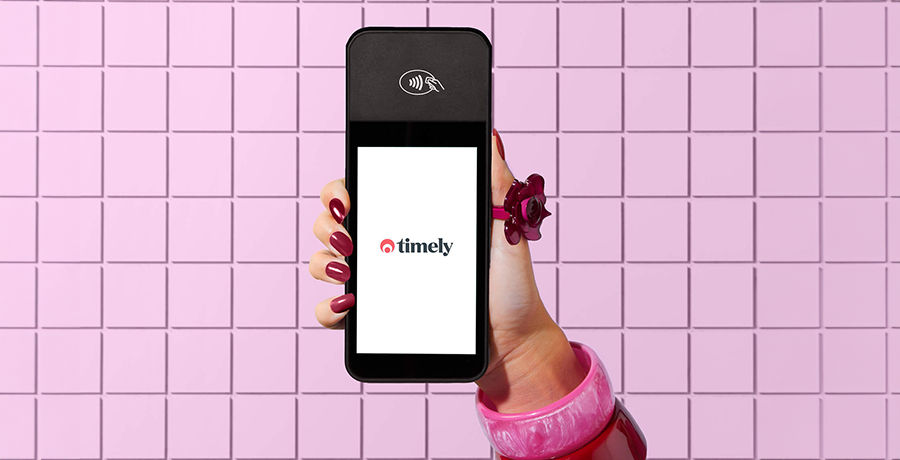 a hand is holding the timely touchscreen terminal.png